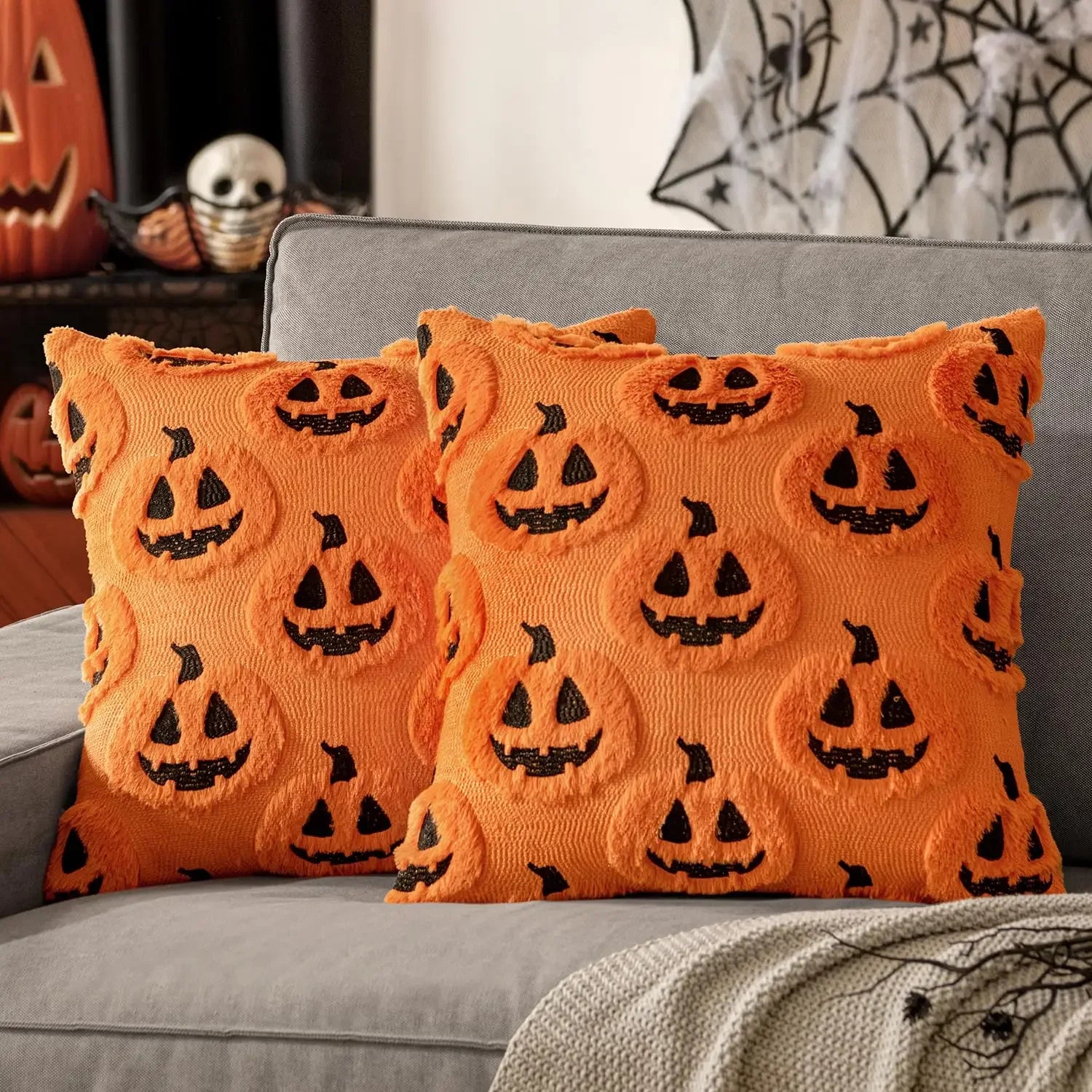 Orange plush Halloween pillow covers with raised jack-o-lantern pumpkin details